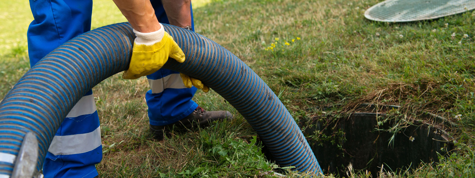 Man Pulling Pipe From a Septic Tank